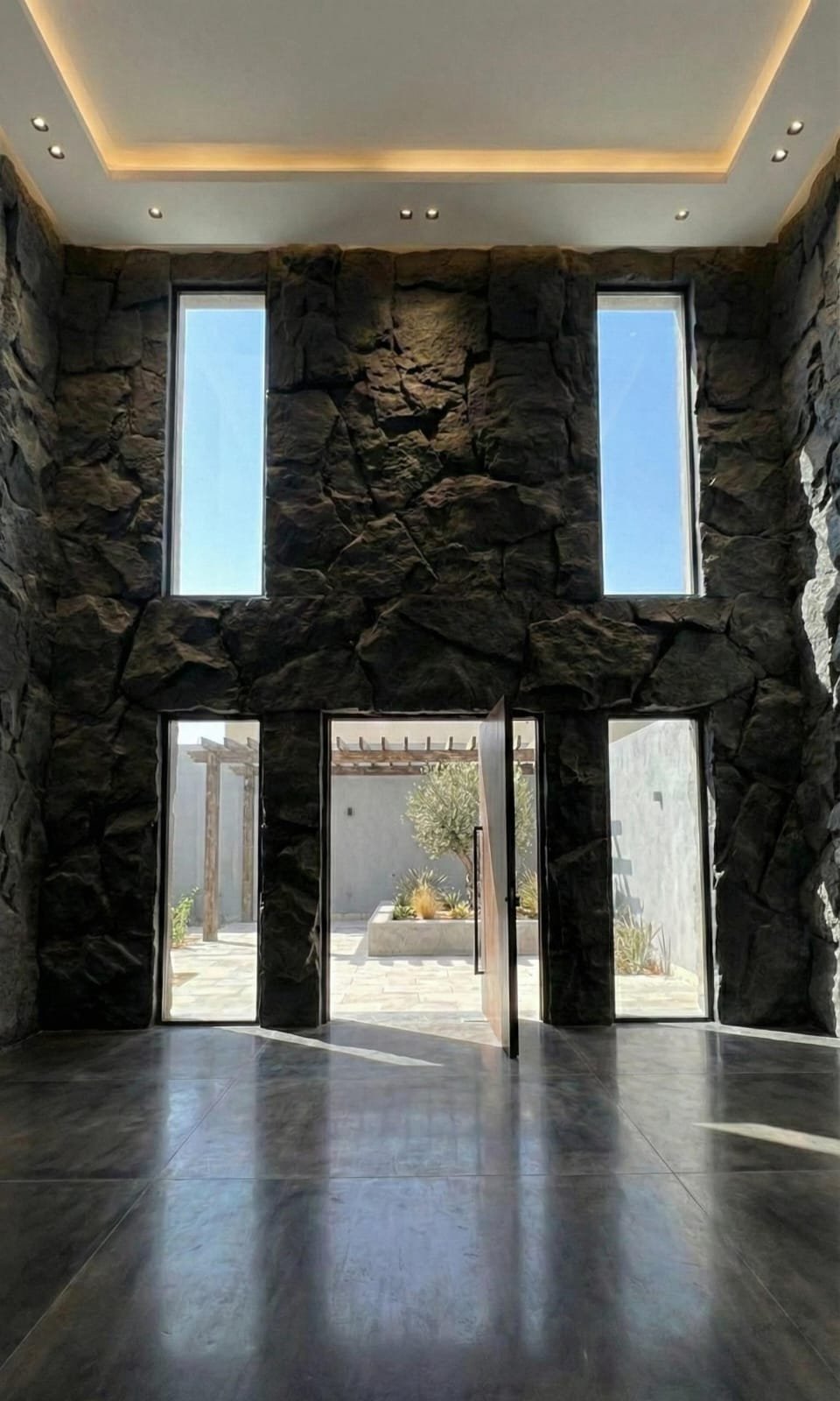 Double-height foyer with basalt rock cladding